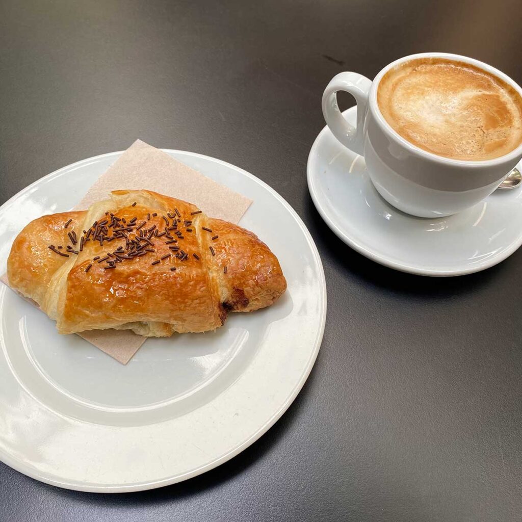 Typical Spanish Breakfast of Coffee and a Pastry in Barcelona, Spain