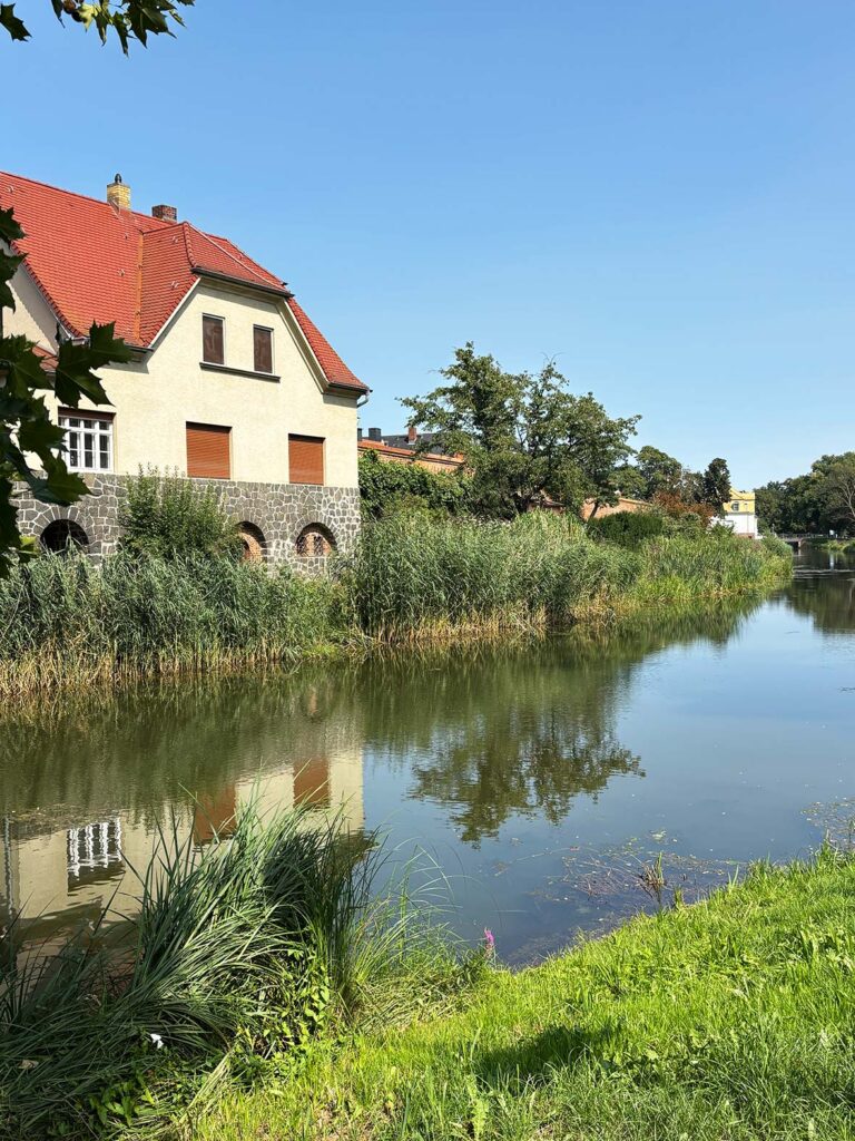 A House With a Red Roof Along the Edge of the Historic Moat Canal in Delitzsch Saxony Germany