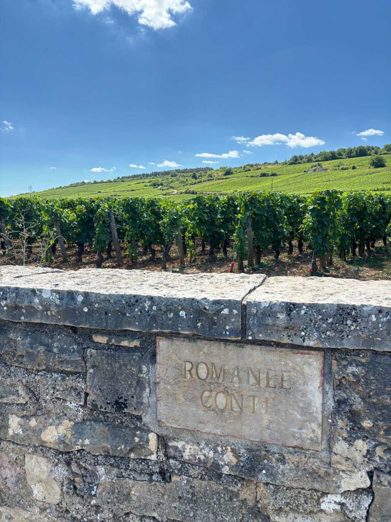 Romanee Conti Sign on a Stone Wall in Front of The Winemaker's Vineyards in Burgundy, France