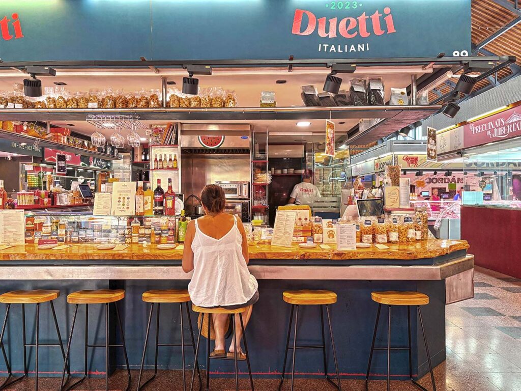 Diners at a Market Vendor in Llibertat Market in Gracia, Barcelona